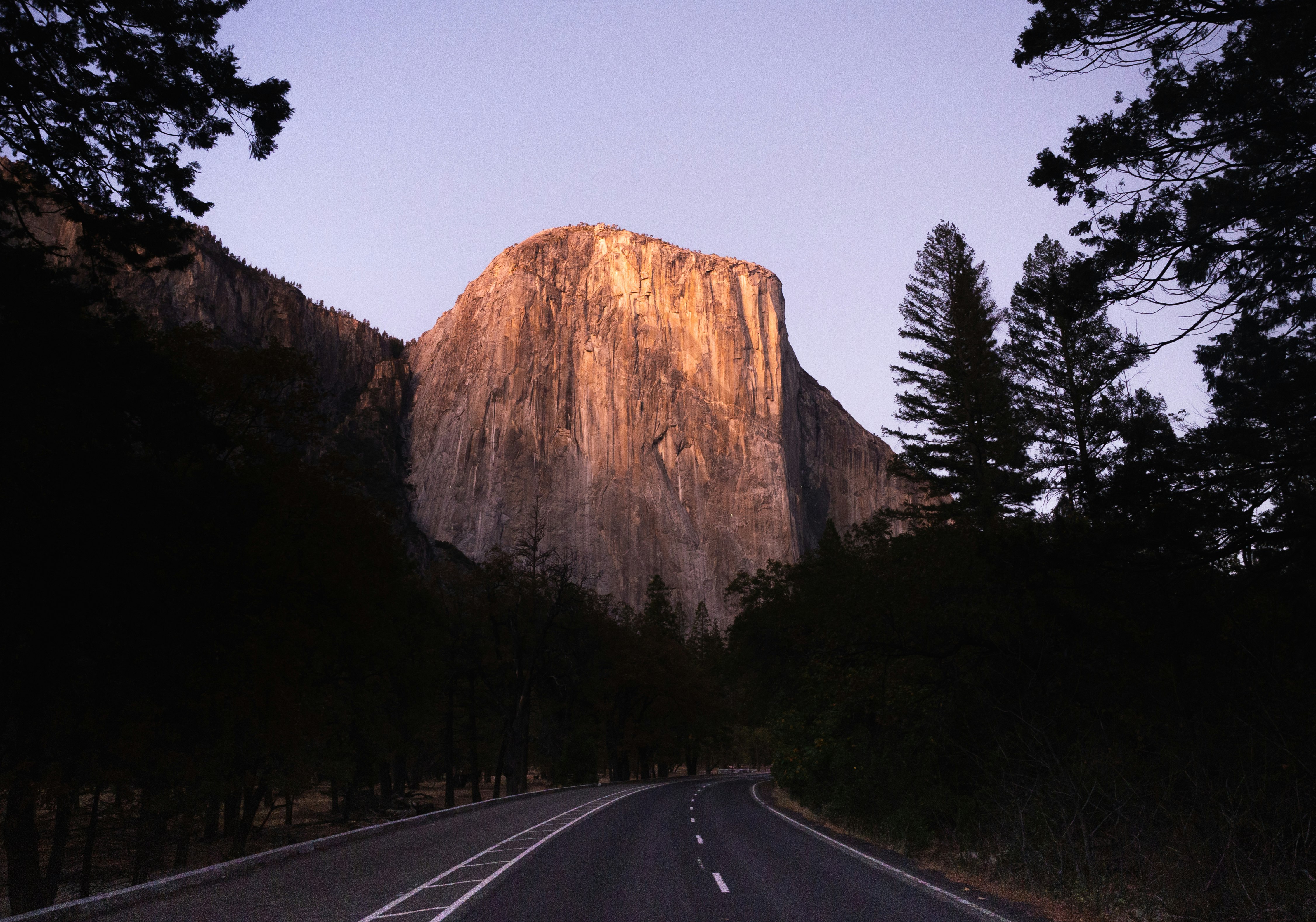 grey road near mountain during daytime